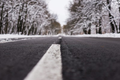 Snow on trees with closeup of the road