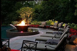 The floating copper fire bowl adjacent an infinity edge pool dazzles guests in a setting often used for large garden parties.