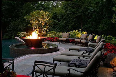 The floating copper fire bowl adjacent an infinity edge pool dazzles guests in a setting often used for large garden parties.