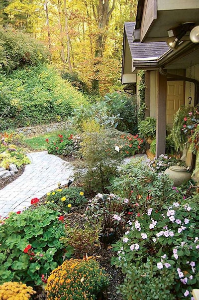 Fotusky and his crew built the paver driveway and walkway and tucked in a small water feature among the plantings, which the homeowner installed.