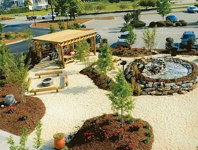 Greater Scapes built benches, a pergola, gas fire pit, gas grill set in blue stone, water feature and six picnic tables for this Murrells Inlet, South Carolina, project.