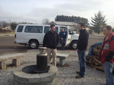 Brad Renner, general manager of Semco Outdoor enjoys lunch with CENTS show patrons at the Semco Outdoor yard, while the Semco shuttle makes a drop-off.