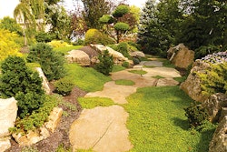 (Above) Their 1-1/2-acre perennial area is organized in alphabetical order to easily pull orders. (Here) The landscapers used diverse plant and stone materials, as well as undulating beds, on this project.