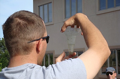 To read a catch can, landscapers should hold it at eye level and record the measurements in millimeters.