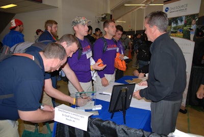 Brian Steel from OneSource talks with Clemson University students during the career fair.