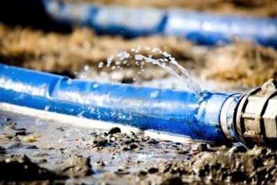 839902-wasting-water--water-leaking-from-a-hole-in-a-hose-shallow-dof-with-focus-on-leak