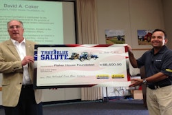 Abe Hughes (right), Vice President of New Holland North America presents a check from the proceeds of past True Blue Salute Programs to David Coker, president of the Fisher House Foundation.