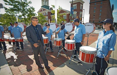 U.S. Lawns President Ken Hutcheson gives thumbs up to the new U.S. Lawns uniform worn by drum corps at the company’s annual conference.