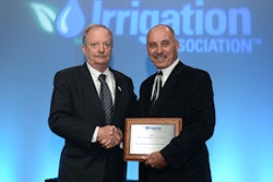 2013 IA President Bob Dobson (left) presents Industry Achievement Award to Vince Nolletti (right) at the 2013 Irrigation Show general session.