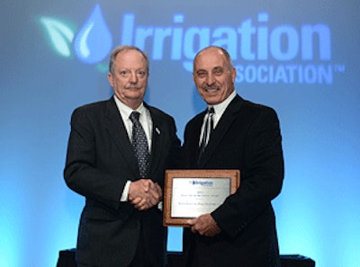 2013 IA President Bob Dobson (left) presents Industry Achievement Award to Vince Nolletti (right) at the 2013 Irrigation Show general session.