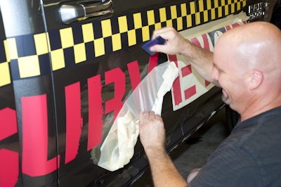 Richard Trahan applies Camoclad-designed/produced custom vinyl graphics to Surveyor 1. Vinyl is a special 3M product that can be easily removed without harming the Ram 2500s’ factory finish.