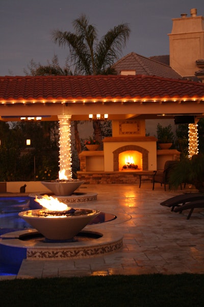 This Los Angeles project includes a fireplace, fire bowls, putting green and swim-up bar. The Green Scene also installed an all-tile, vanishing edge swimming pool. Photo: The Green Scene