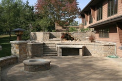 The design of this space grows from perfect circles. The materials are natural stone, Unilock II Campo pavers and Belgard retaining walls.