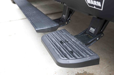 Amp Research power running boards and corner bed steps on each side make it easy to get in/out of the cab or secure items on the topper’s cargo rack.