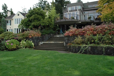Located on Lake Oswego in Oregon, this project features a backyard that incorporates walls made from local basalt and concrete stairs with slate insets.