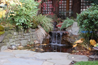 Built into a stone wall and integrated with an adjacent Bluestone patio, this project uses a small water feature surrounded by natural elements that serves as the focal point for an entry courtyard.