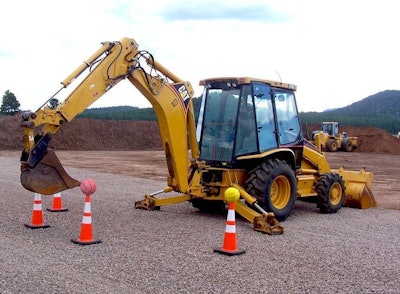 A patron at Big Toy Playground attempts to use a backhoe bucket to remove a basketball from a cone. Credit: Big Toy Playground