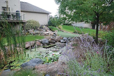 Located in Carver, Minnesota, this backyard project includes a water garden, putting green and deck.