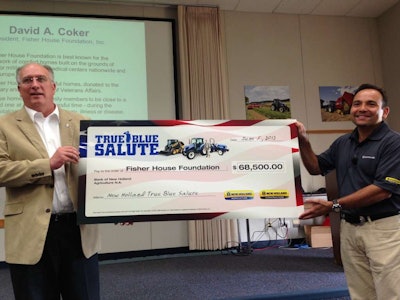Abe Hughes (right), Vice President of New Holland North America presented a check last June from the proceeds of past True Blue Salute Programs to David Coker, president of the Fisher House Foundation.