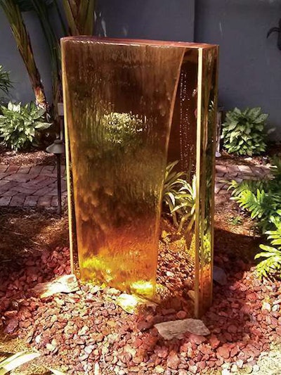 Gourmet Landscaping Services created a custom feature using gold acrylic mirrors on all sides in Fort Lauderdale, Florida.