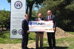 Paul Wade, New Holland Construction Marketing Manager, (center) presented a check for $57,800 to Fisher House Foundation Chairman/CEO Ken Fisher (left) and President David Coker (right).