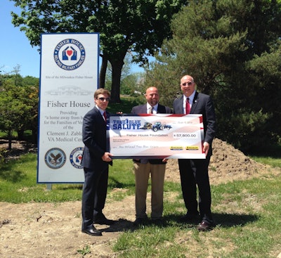 Paul Wade, New Holland Construction Marketing Manager, (center) presented a check for $57,800 to Fisher House Foundation Chairman/CEO Ken Fisher (left) and President David Coker (right).