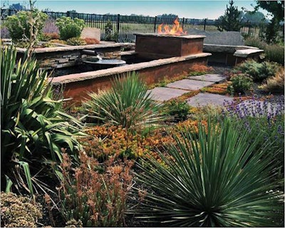 Water flows into a copper bowl and then cascades into a reflecting pool. A fire feature surrounded by seating provides warmth.