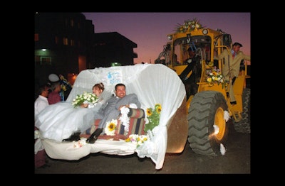 Why ride in a limo to your wedding reception when you could sit on a couch in a bucket? I don’t think the added flower arrangements help take away from the fact that the equipment is transporting you like it would a pile of dirt.