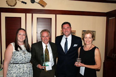 Mark and Kay Halla accept awards for being named one of 12 Landscaper of the Year finalists. Pictured left to right: Lauren Heartsill Dowdle, Editor-At-Large for Total Landscape Care; Mark Halla; Warren Anderson, brand marketing manager for Case Construction Equipment; and Kay Halla.