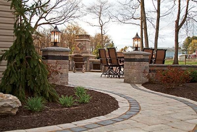 Bolder Concepts Landscape & Design used Unilock Brussels pavers and wall blocks with Unilock Courtstone banding. They also used Courtstone to create an hearth area for the fireplace.