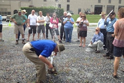 IA Past President Bob Dobson, CIC, CID, shows the group how to use a teaching tool during the event’s hydraulics lab.