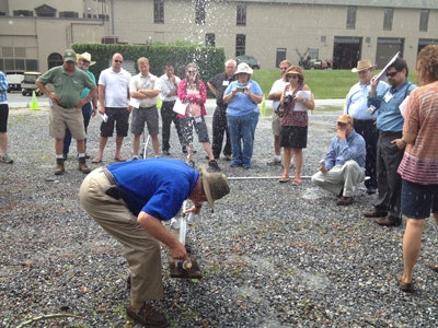IA Past President Bob Dobson, CIC, CID, shows the group how to use a teaching tool during the event’s hydraulics lab.