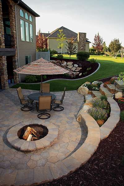 Springfalls Nursery & Landscaping used natural steps with Belgard Mega Arbel pavers for this backyard patio project.