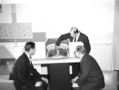 Architect Kevin Roche explains the unique balcony design to Hewitt (left) and Saarinen. The auditorium was designed with a reverse balcony in which the lowest tier of seats is situated to the rear of the auditorium with each succeeding tier closer to the