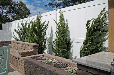 The small space includes container plantings and large palms, which were lifted in with a crane.