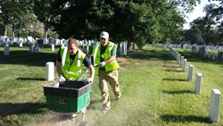 Tom Warfel (left) helps a fellow volunteer at Renewal and Remembrance.