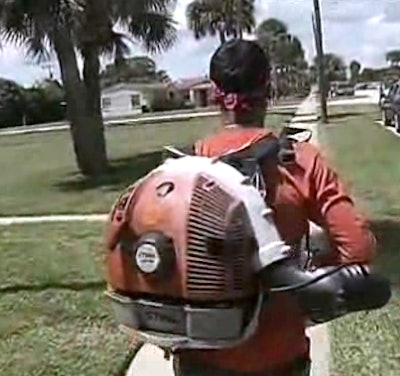 Carlos Repicio blows grass from the sidewalk, like he did the morning of the attack.