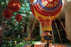 The hot air balloon, which weighs 4,000 pounds, is surrounded by theatrical lighting and music.