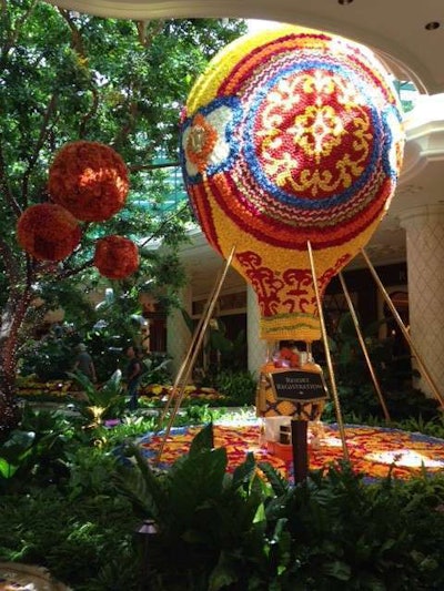The hot air balloon, which weighs 4,000 pounds, is surrounded by theatrical lighting and music.
