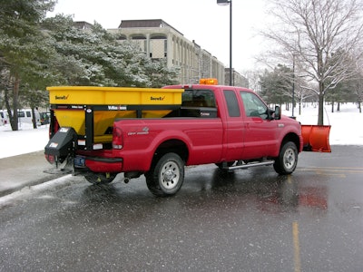 Photo of a Red Truck Salting a Parking Lot in Winter