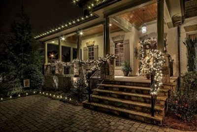 For clients wanting a more traditional design, Christmas Décor uses white lights with greenery along this residential porch.