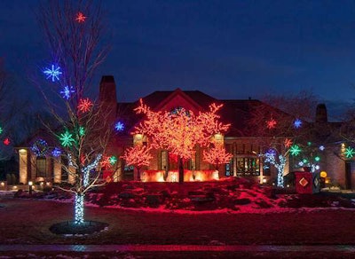 McKay Landscape Lighting installed three LED cherry blossom trees and one 16-foot and two 8-foot trees that rotate through the RGB color wheel. They also added 24-inch LED red, green and blue starbursts hanging in the crabapple trees with LED white minis wrapped around the trunk. On the house, they hung a 5-foot LED multi-color wreath.
