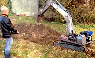 Kid-with-RC-excavator-digging-trench