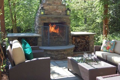 Fieldstone fireplace with raised bluestone hearth becomes an attractive focal point in the yard. Photo: Heidi Miscovic, Borst Landscape and Design