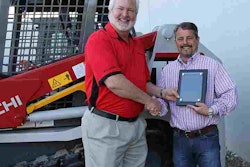 Dale McLemore, Takeuchi Regional Business Manager, presents Jimi Martin of Perimeter Takeuchi, the 2014 Salesman of the Year award.