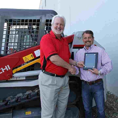 Dale McLemore, Takeuchi Regional Business Manager, presents Jimi Martin of Perimeter Takeuchi, the 2014 Salesman of the Year award.