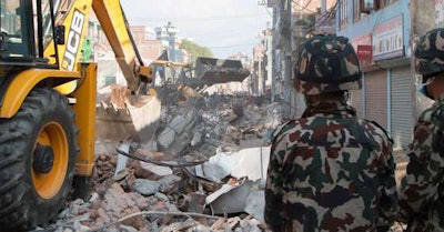 A JCB backhoe clearing debris in Kathmandu, Nepal, after their second earthquake.