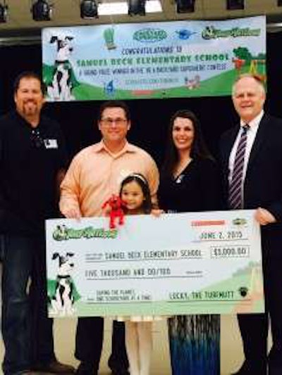 Contest winner Jordan Evans poses with parents and representatives of Scholastic, OPEI