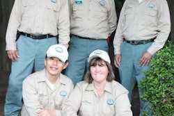 David and Kathy Lee, front, pose with their landscaping crew.