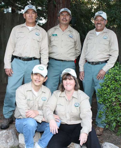 David and Kathy Lee, front, pose with their landscaping crew.